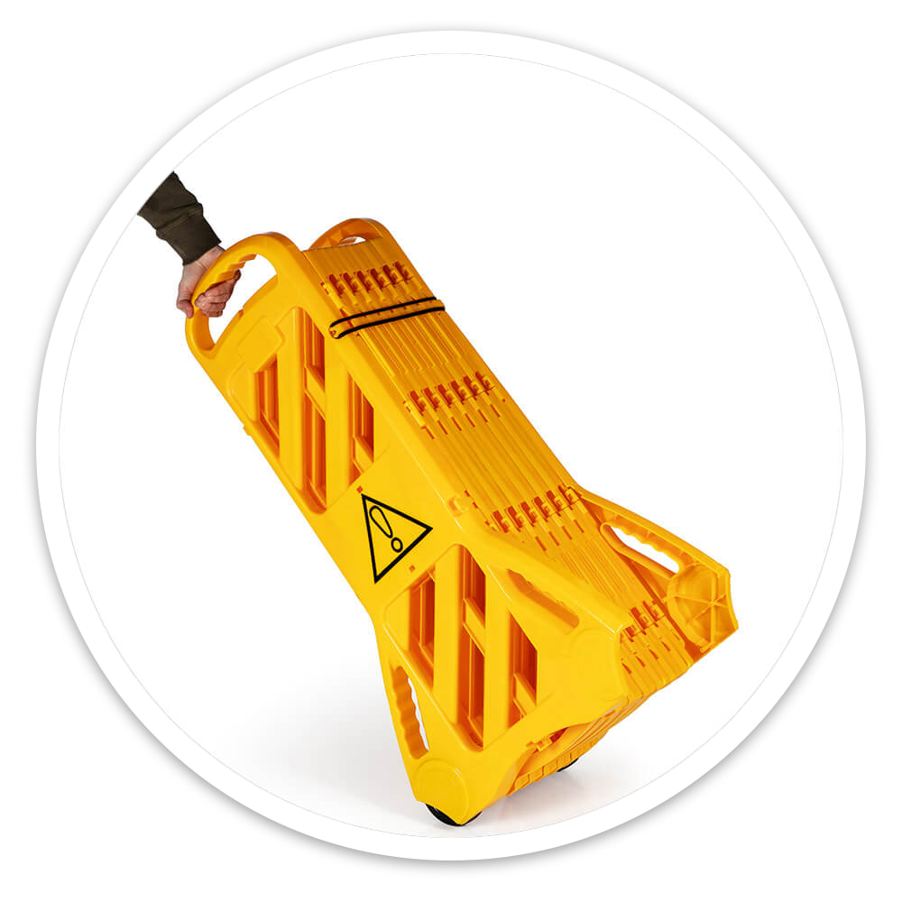 Hand pulling the folded Portable Expanding Barrier by its handle on its wheels