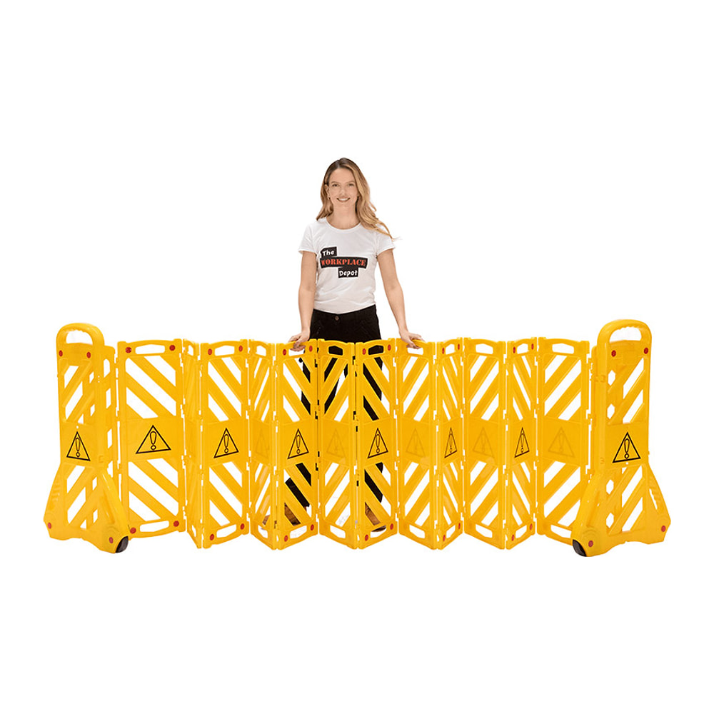 Woman standing behind the yellow Portable Expanding Barrier, fully opened, on a white background