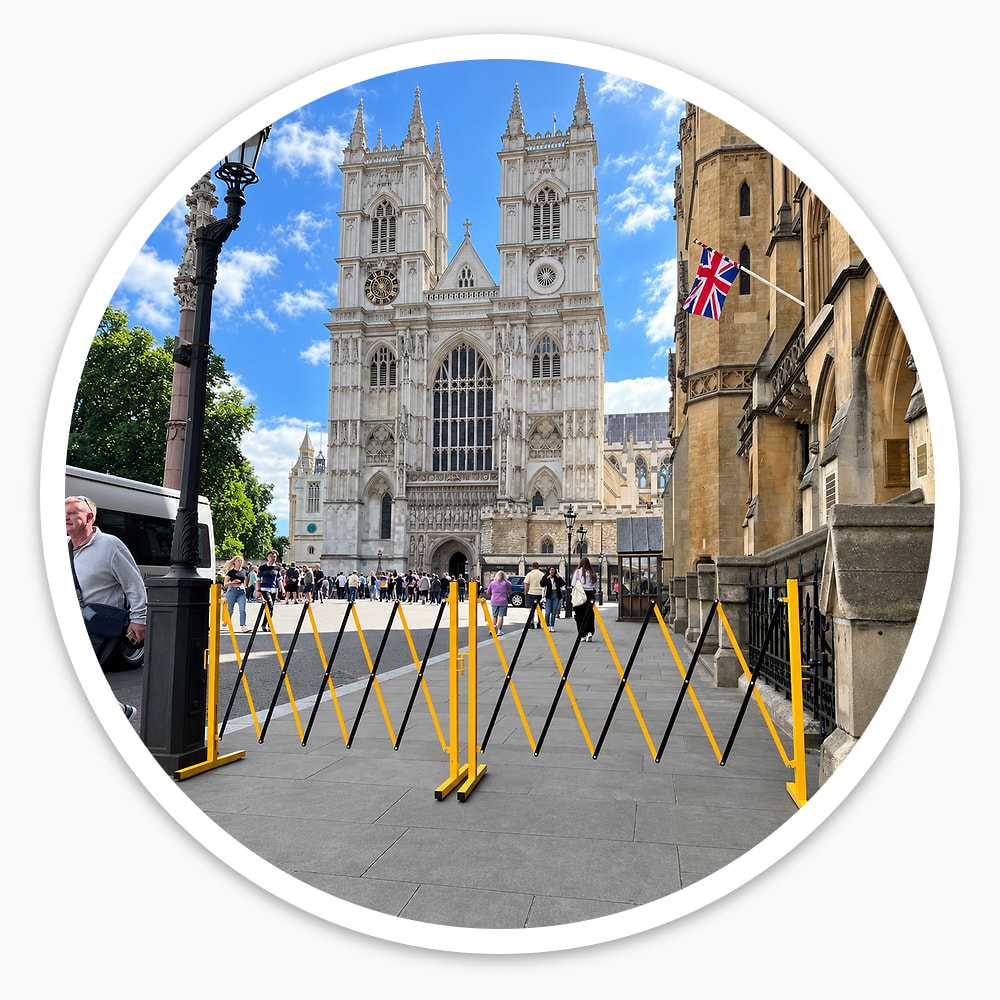 Two Small Expanding Safety Barriers linked end to end across a pavement near Westminster Abbey