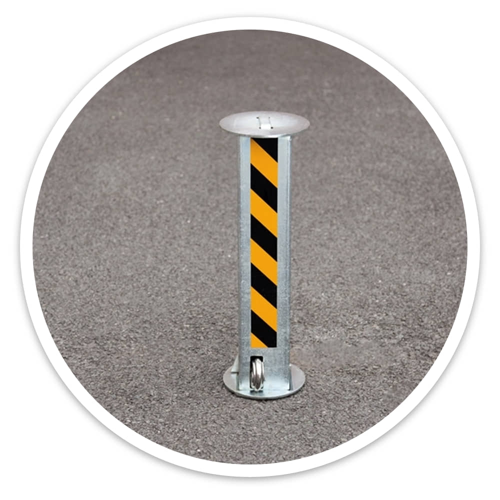 Manual Rising Security Post raised to 520mm on tarmac, showing its black and yellow striped post