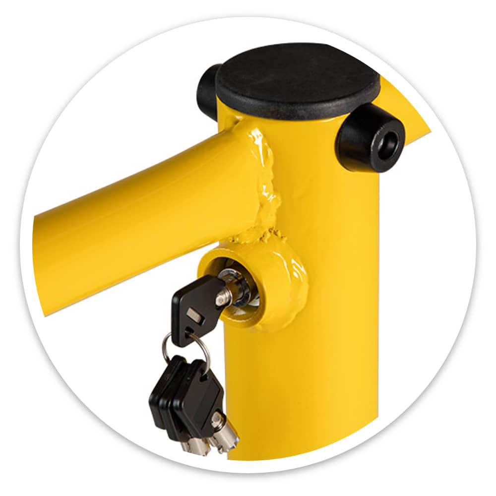 Close-up of the folding parking barrier's integral lock with a set of keys in it