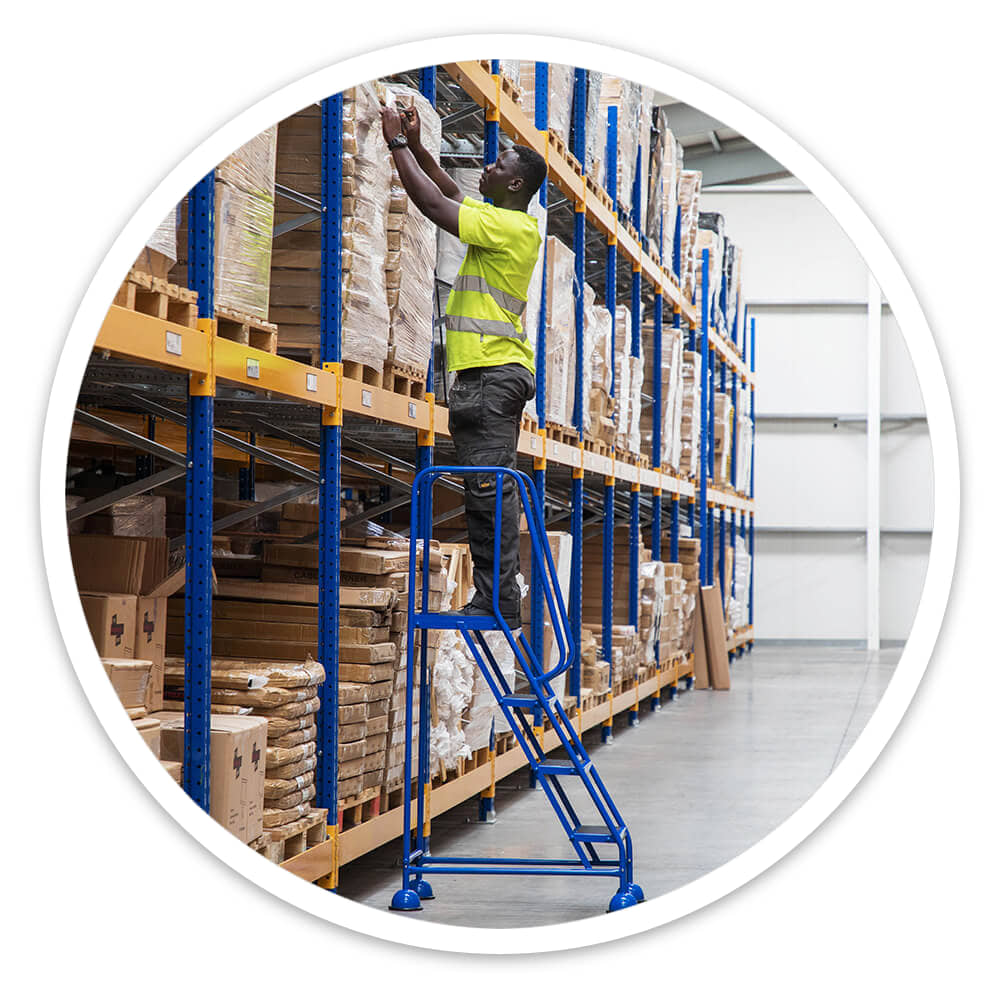 Warehouse operative reaching high racking from the 4 Tread Mobile Safety Steps