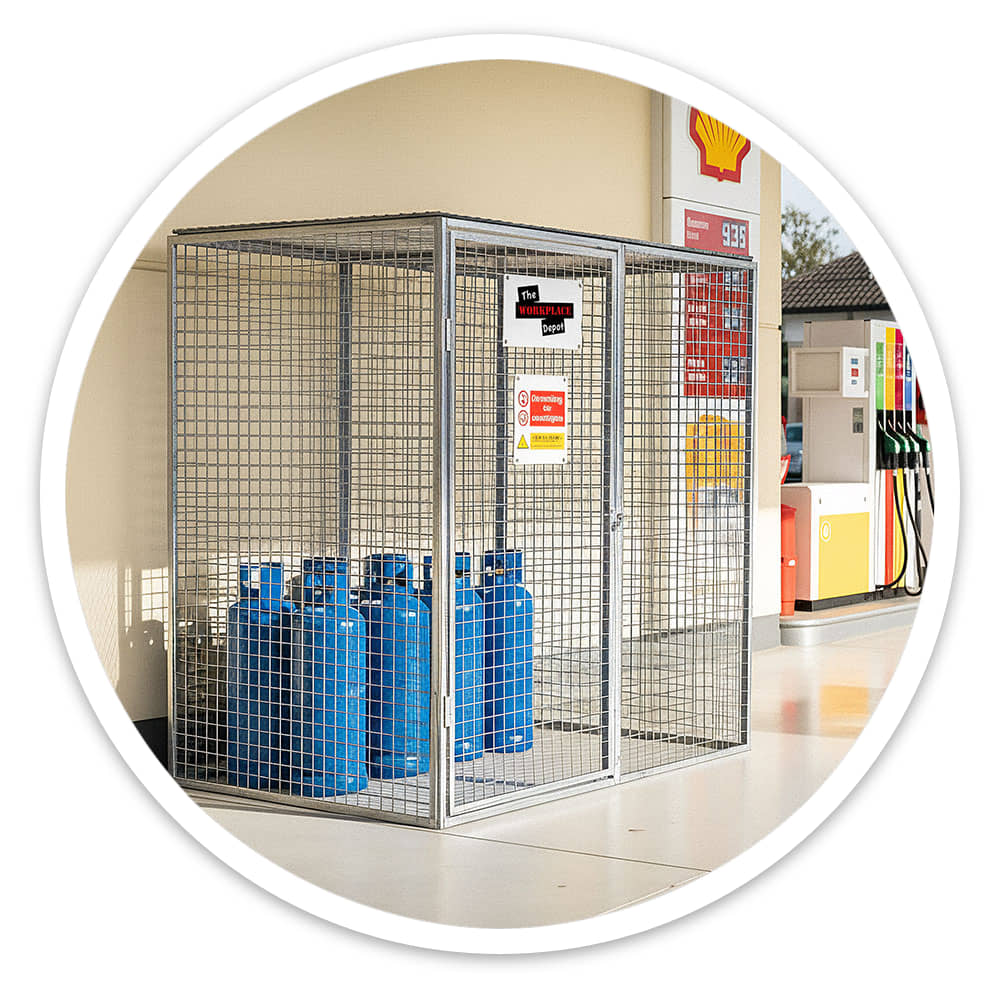 Blue gas cylinders clearly visible through the mesh of a gas cylinder cage at a petrol station