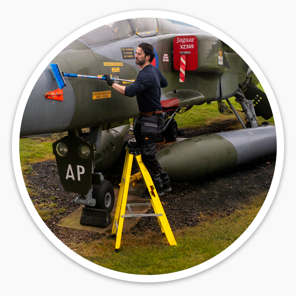 Engineer cleaning a jet aircraft outdoors while standing on the 4 Tread Fibreglass Step Ladder