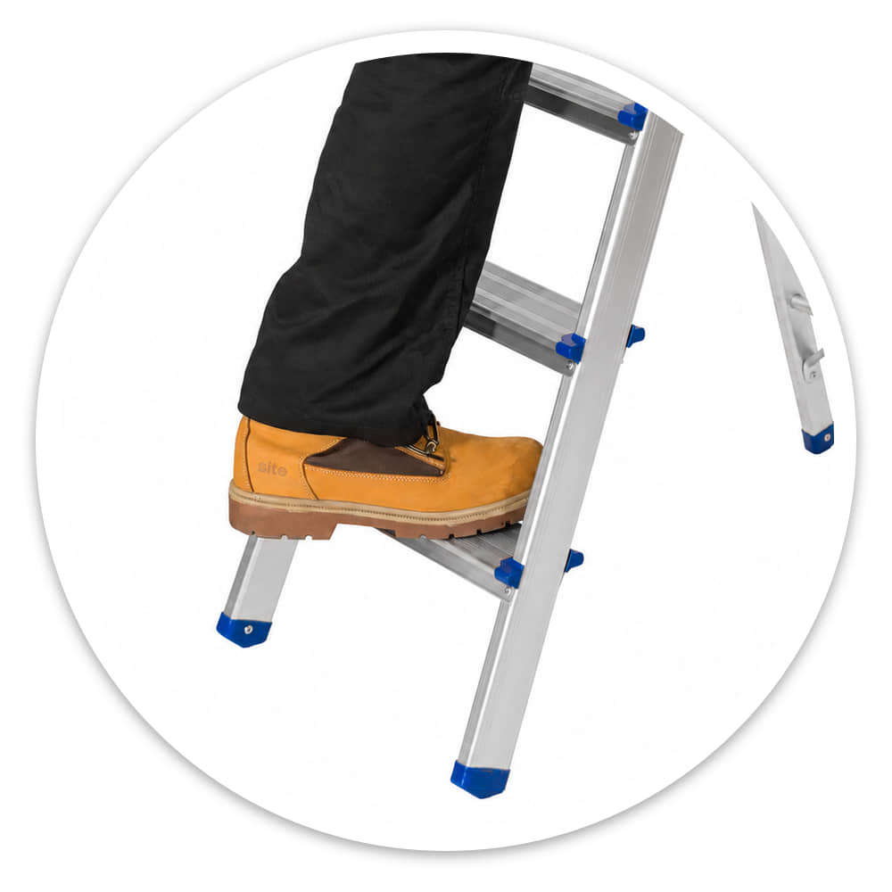 Close-up of work boots gripping the wide anti-slip treads of the 4 Tread Lightweight Aluminium Step Ladder