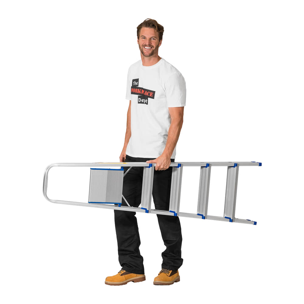 Man carrying the folded 5 Tread Lightweight Aluminium Step Ladder one-handed against a white background