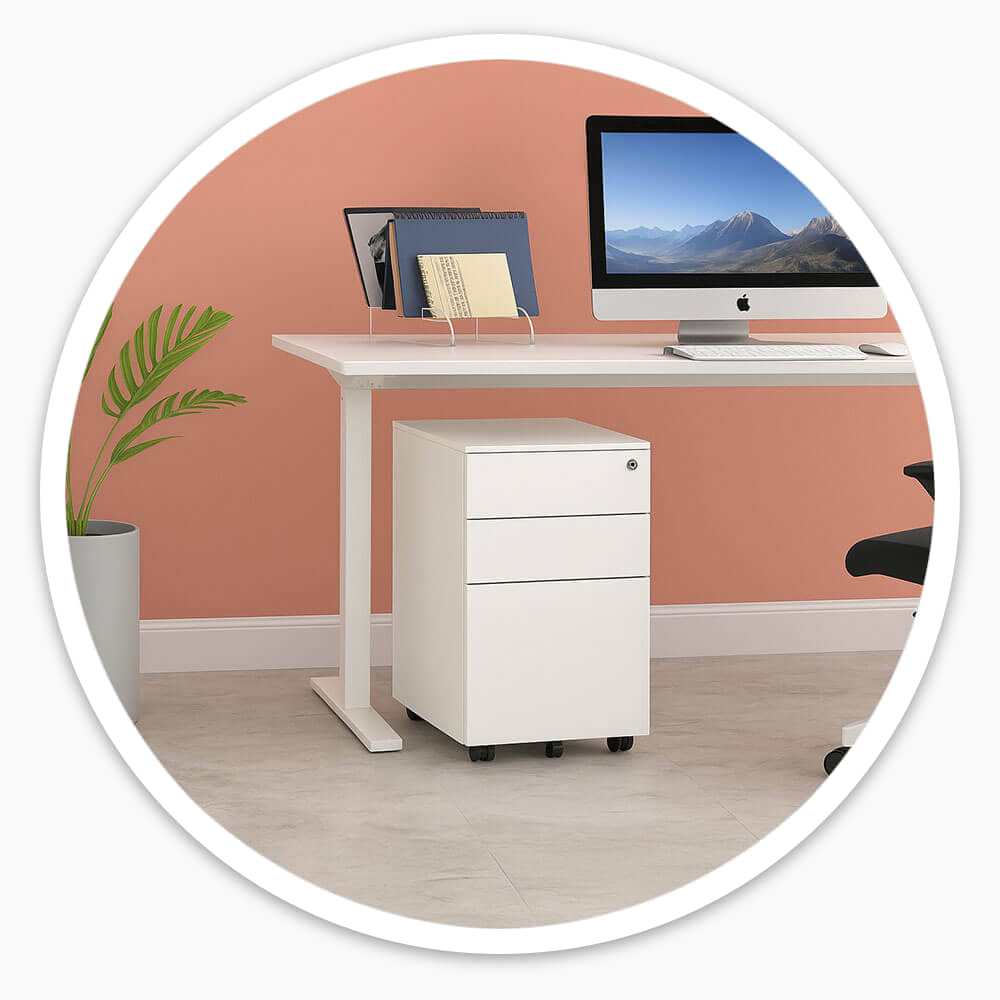 White 3 drawer mobile steel pedestal on castors beside a white desk with a computer monitor, in an office with a terracotta wall