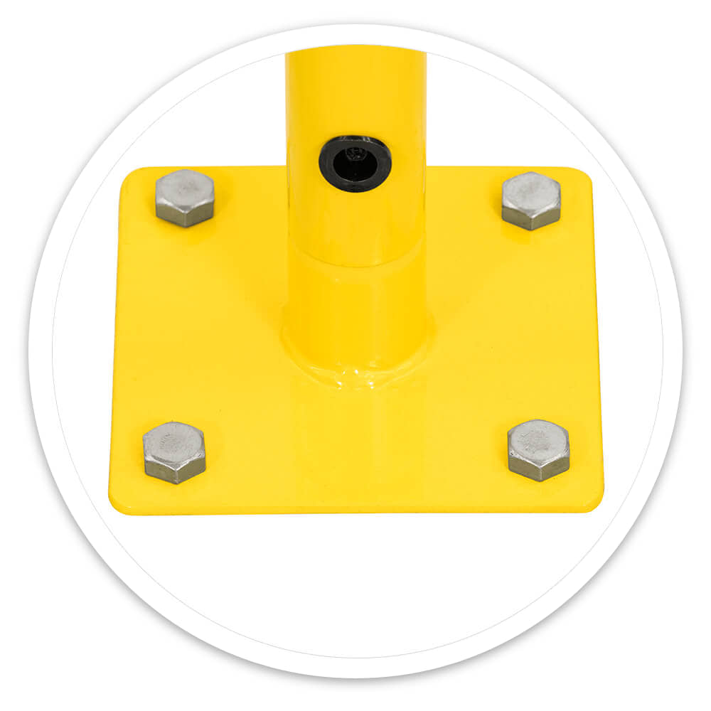 Close-up of a walkway barrier's yellow 150mm square base plate with four fixing bolts