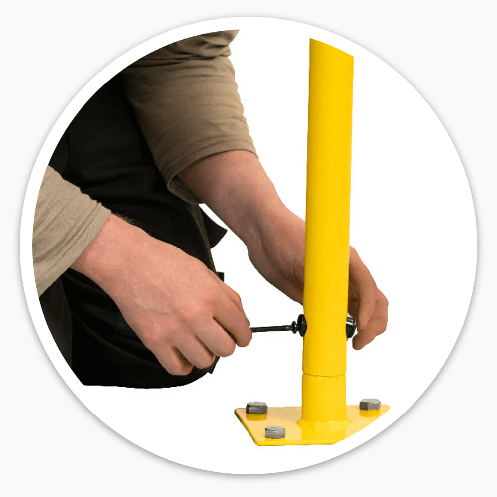 Fitter tightening the fixing bolt on a safety railing upright above its bolt-down base plate