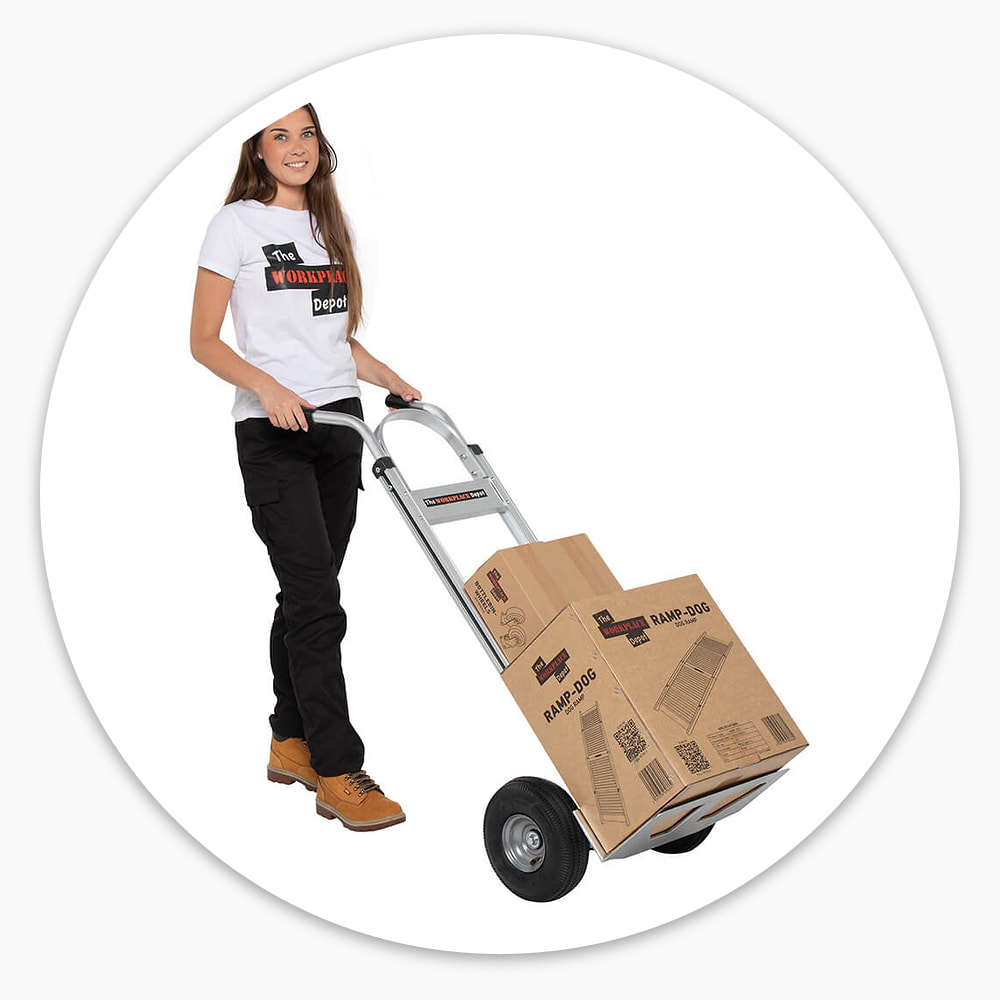 Woman wheeling the aluminium sack truck with pneumatic tyres one-handed, carrying two cardboard boxes