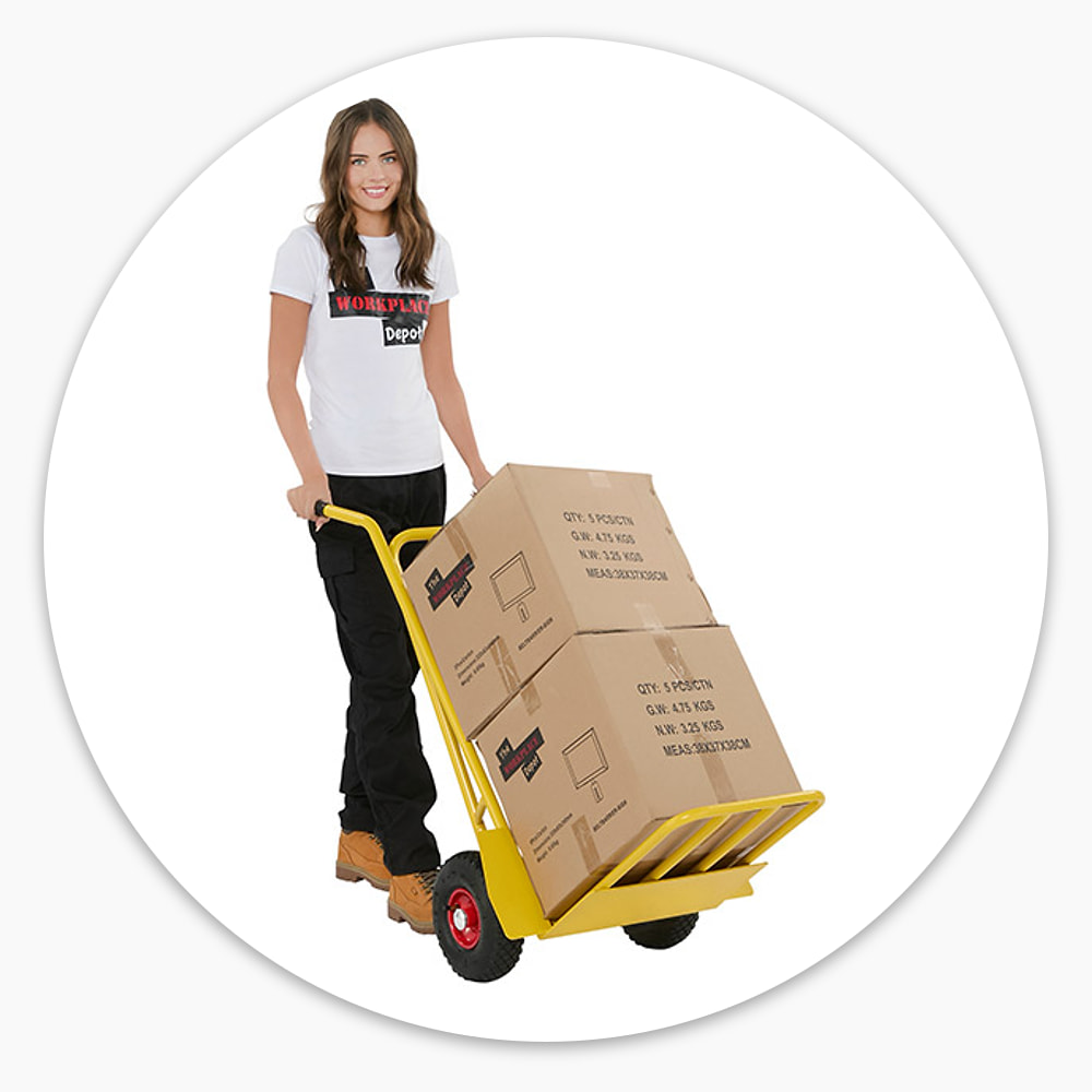 Woman wheeling two large cardboard boxes on the yellow Delivery Trolley with folding toe plate and red-hubbed pneumatic wheels