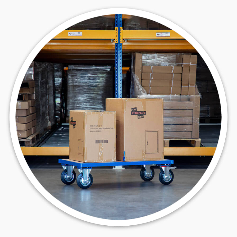 Platform Dolly Cart carrying stacked cardboard boxes beside pallet racking in a warehouse