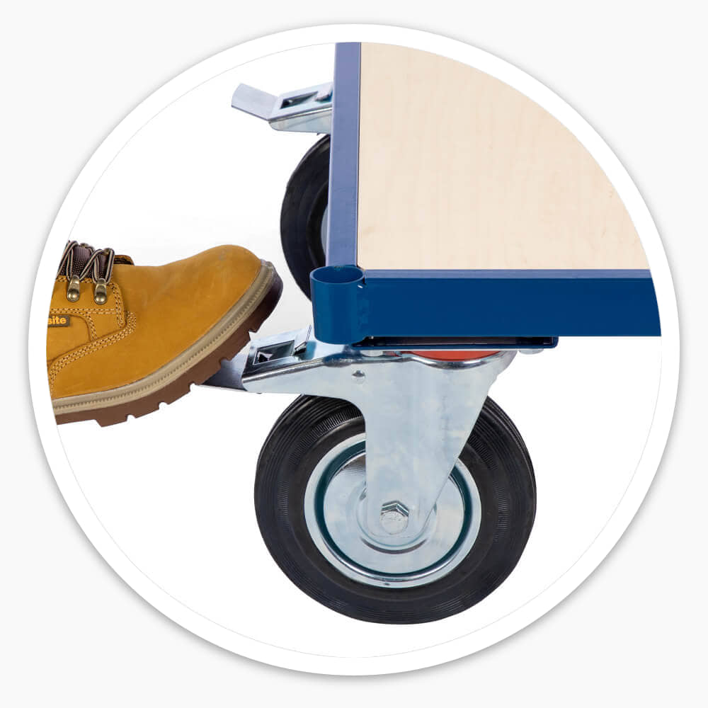 Work boot pressing the foot-operated brake on a Platform Dolly Cart swivel castor
