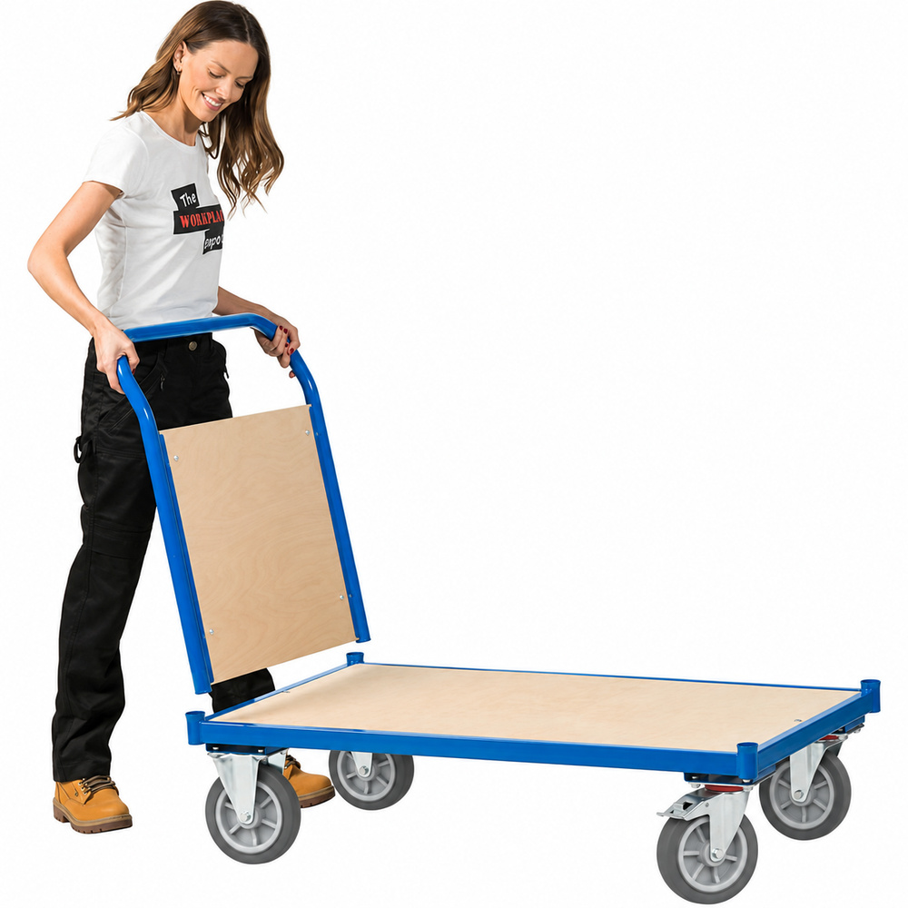 Woman pushing the blue flatbed trolley with push handle, its plywood-backed handle slotted into the steel frame's corner sockets