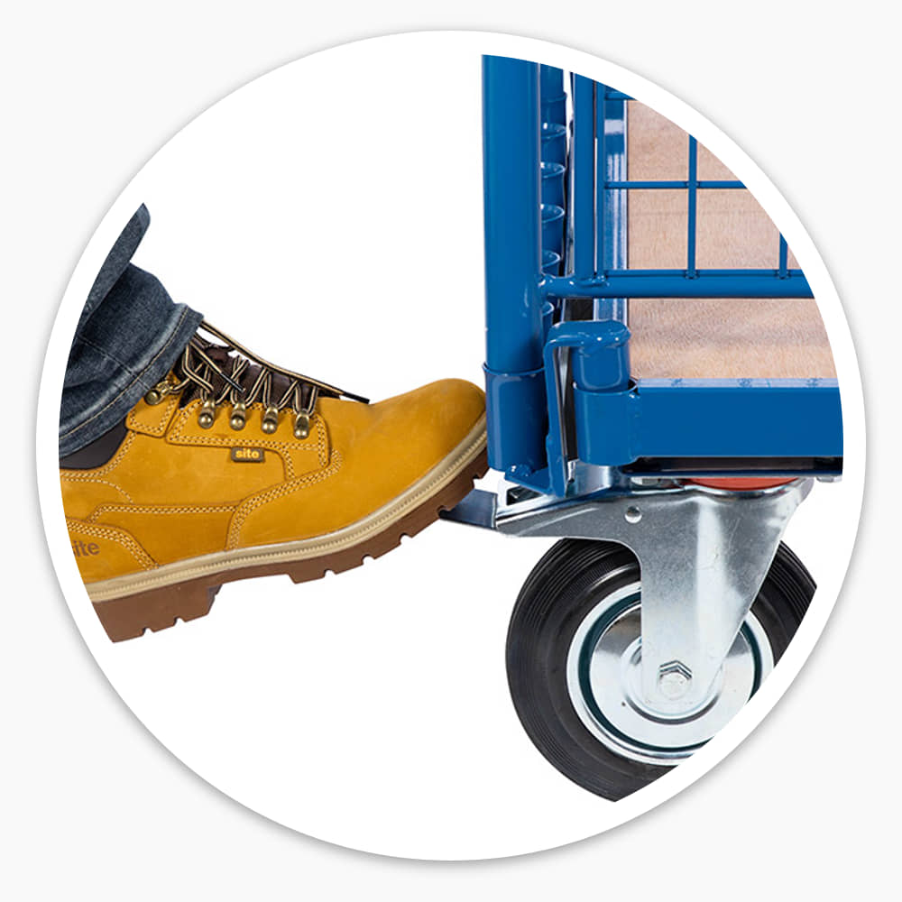 Work boot pressing the foot-operated brake on a swivel castor of the Adjustable Board Trolley