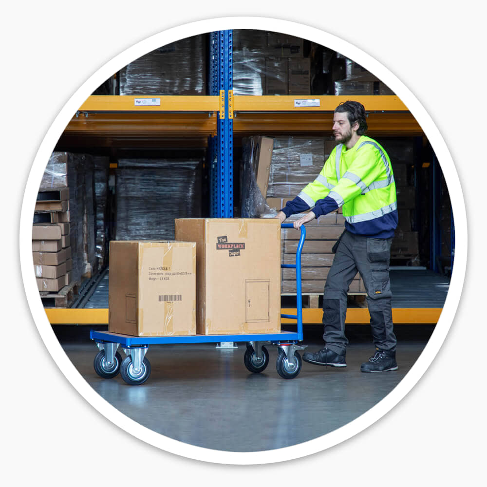 Warehouse worker pushing a loaded Platform Truck by its single fitted handle