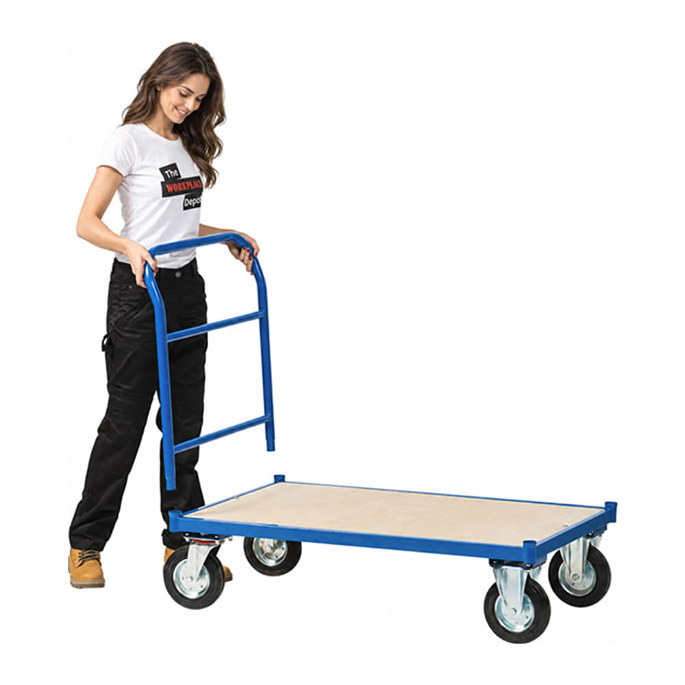 Woman pushing the blue steel Platform Truck - Fitted Handle - 500kg Maximum Load, with a plywood deck and four castors