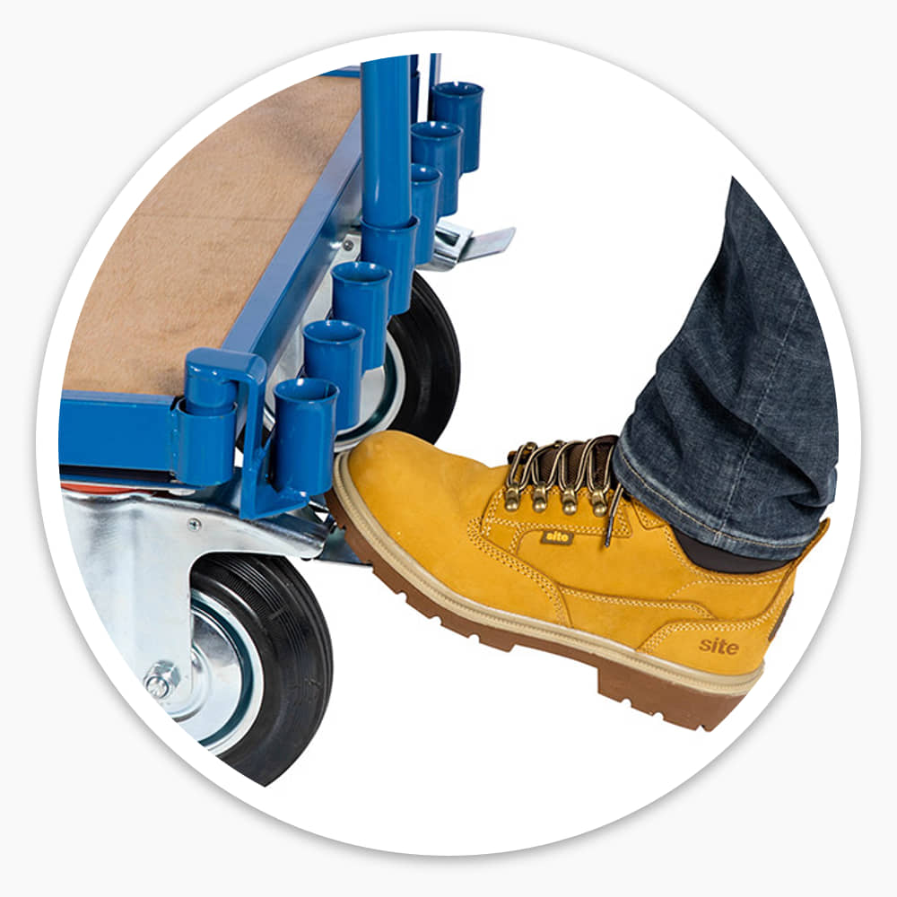 Work boot pressing the foot-operated brake on a Sheet Material Trolley swivel castor