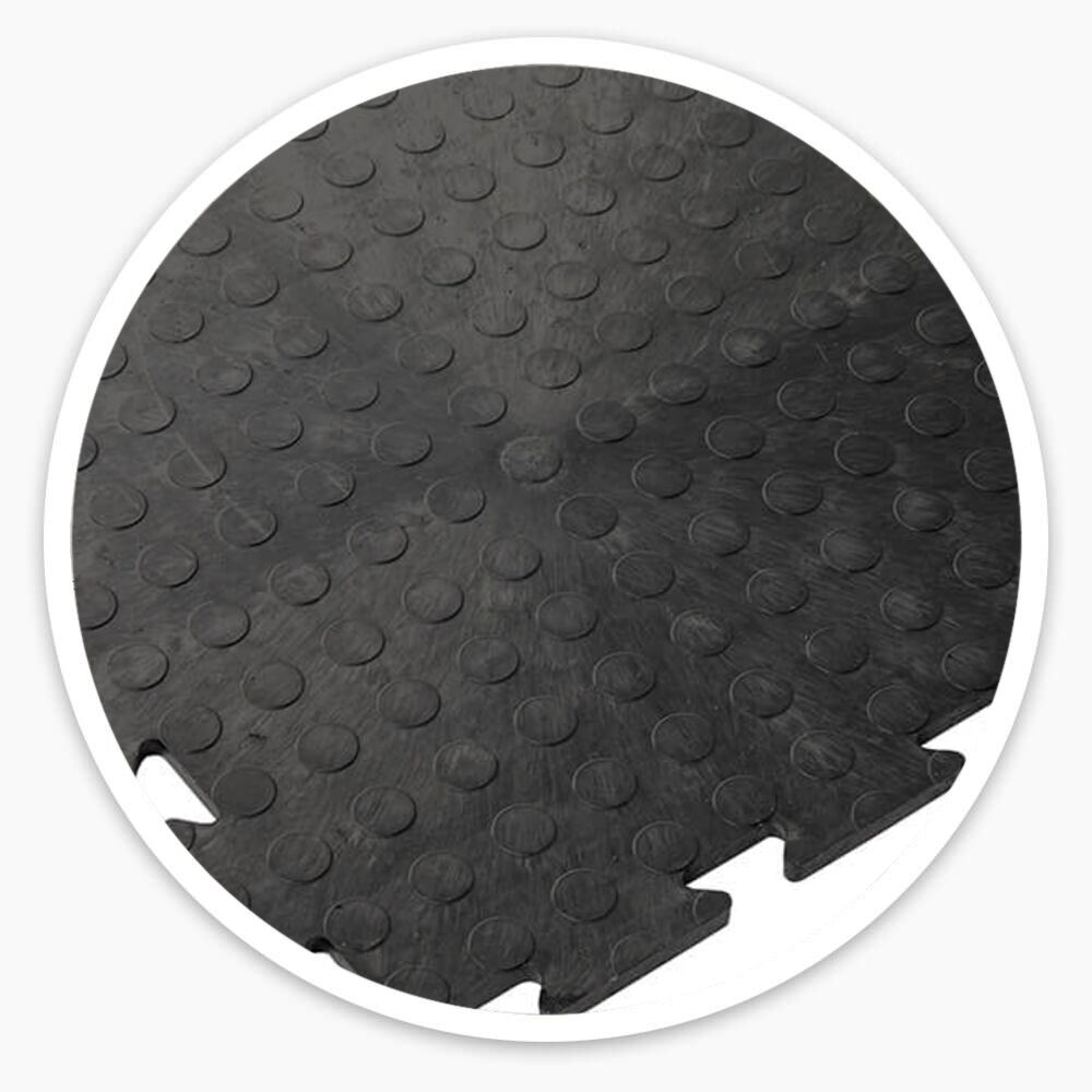 Black interlocking vinyl floor tiles with raised dotted surface