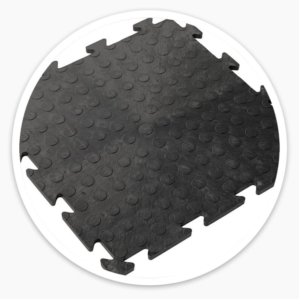 Black interlocking vinyl floor tiles with raised dotted surface